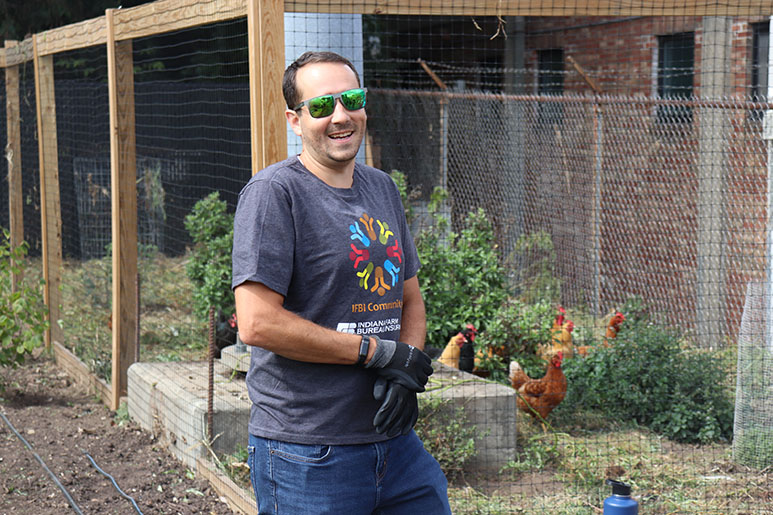 Indiana Farm Bureau Insurance employee with an Indiana Farm Bureau Insurance community shirt on volunteering at Growing Places Indy