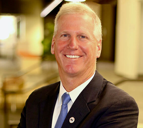 Photo of Kevin Murphy smiling with an Indiana Farm Bureau Insurance pin on his jacket